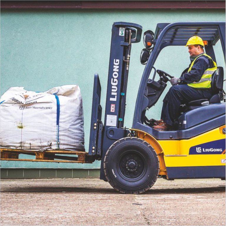 Forklift handling material at a site